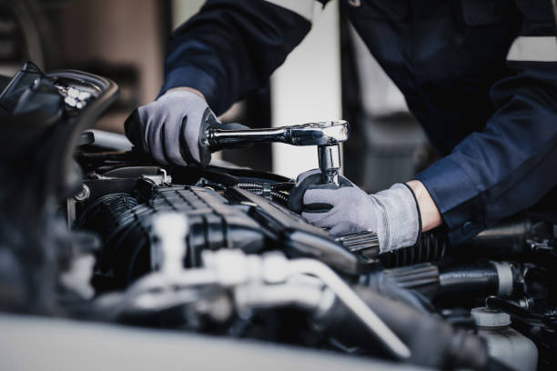 Mechanic servicing truck in modern garage